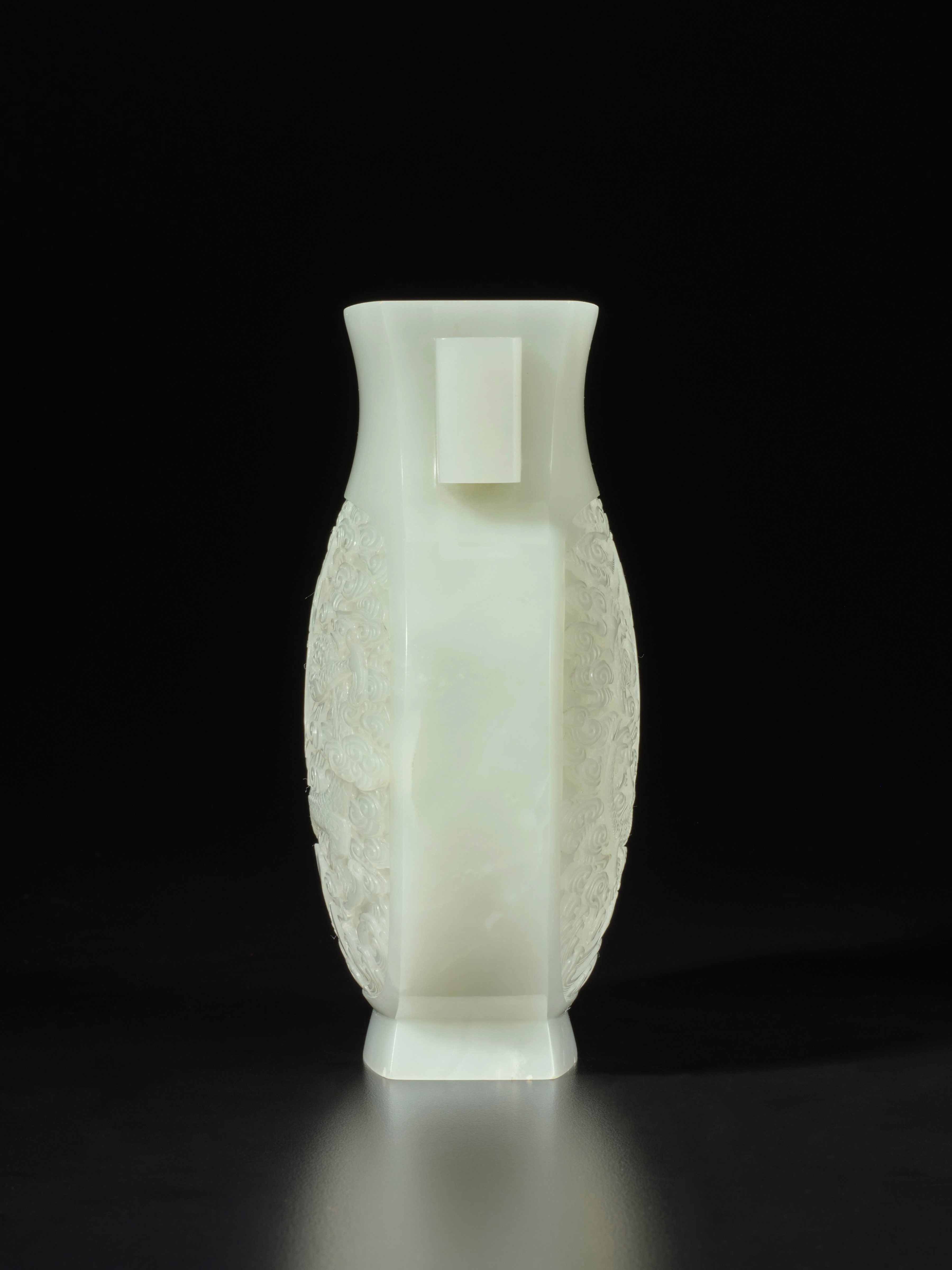 A superbly carved white jade 'dragon' vase, Qing dynasty, Qianlong period 清乾隆 白玉雕雲龍戲珠紋雙耳瓶
