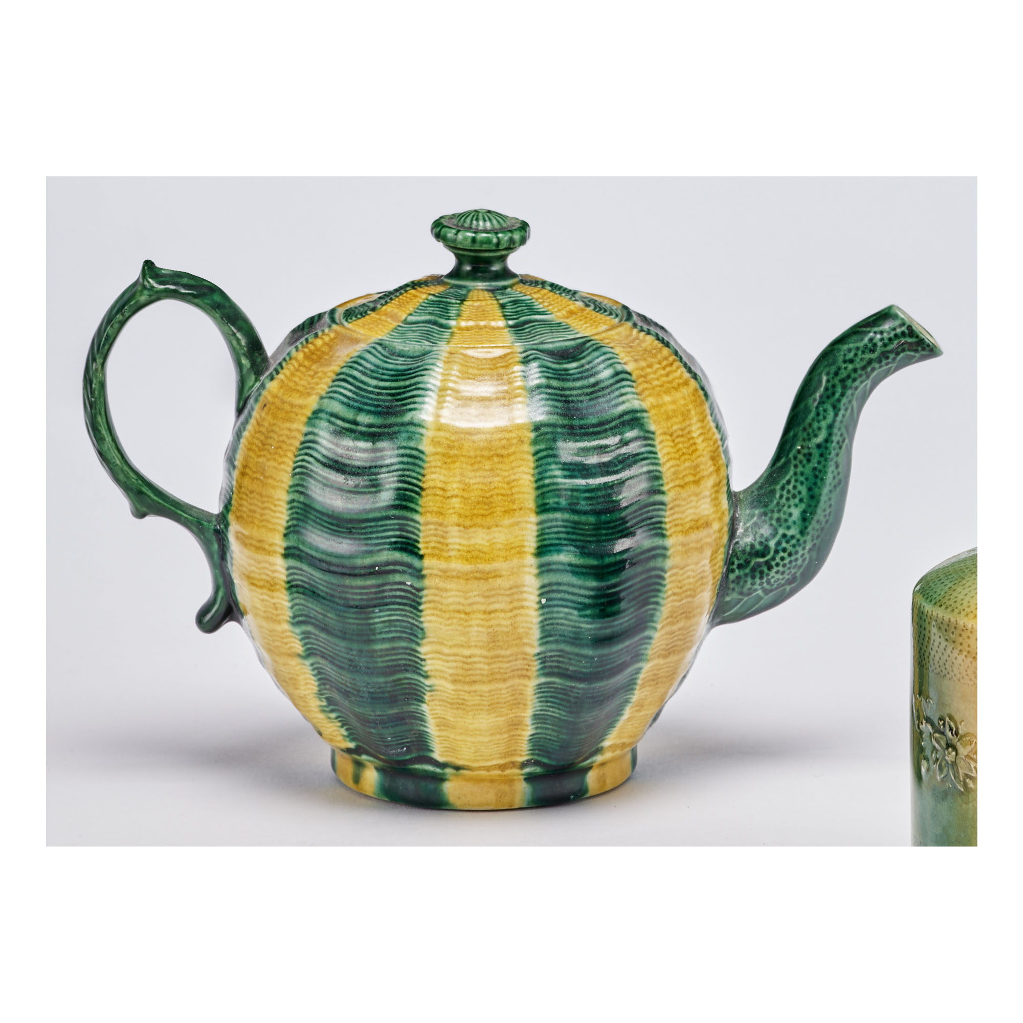 A WEDGWOOD LEADGLAZED CREAMCOLORED EARTHENWARE MELON TEAPOT AND COVER