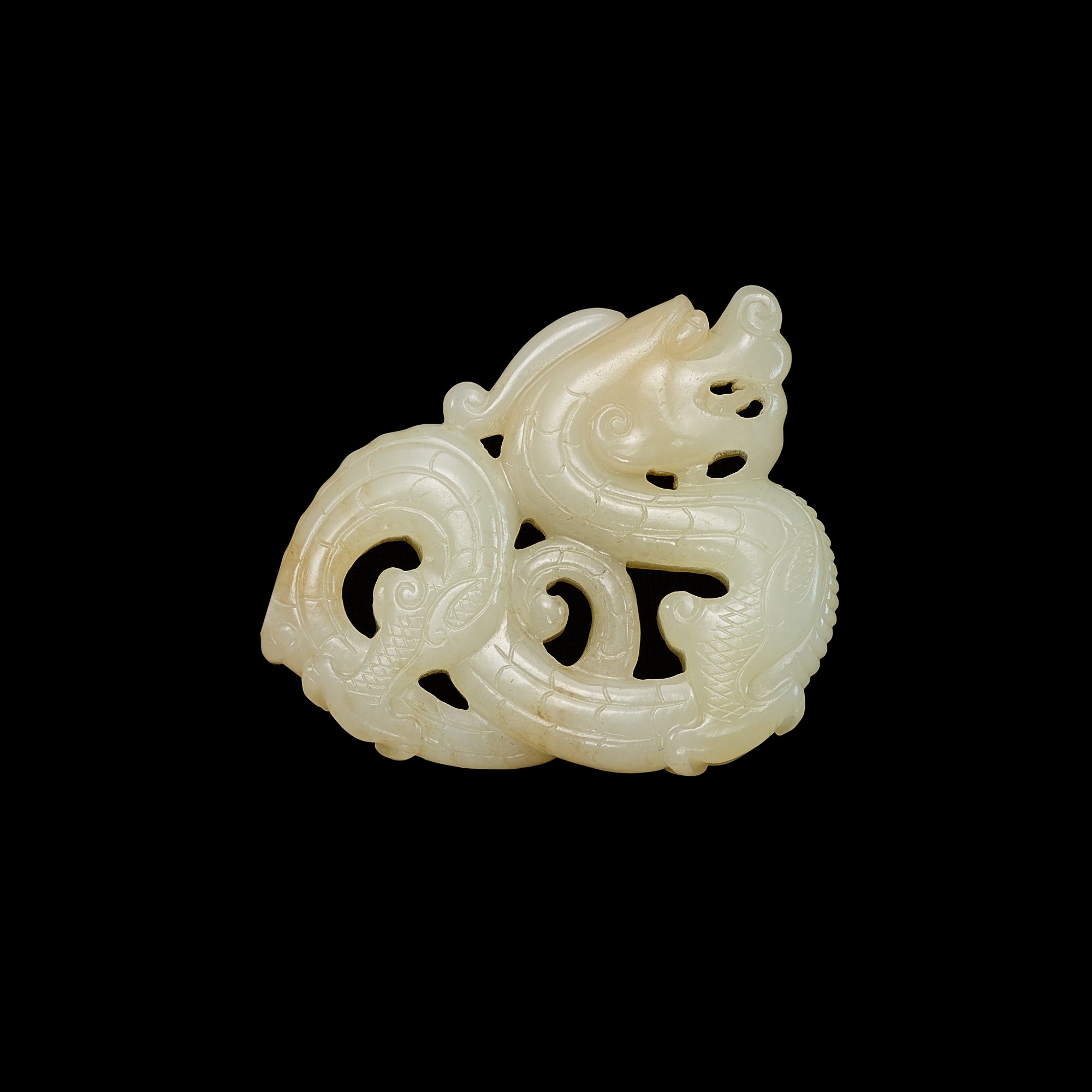 A white jade openwork 'dragon' plaque, Ming dynasty 明 白玉鏤雕龍紋珮