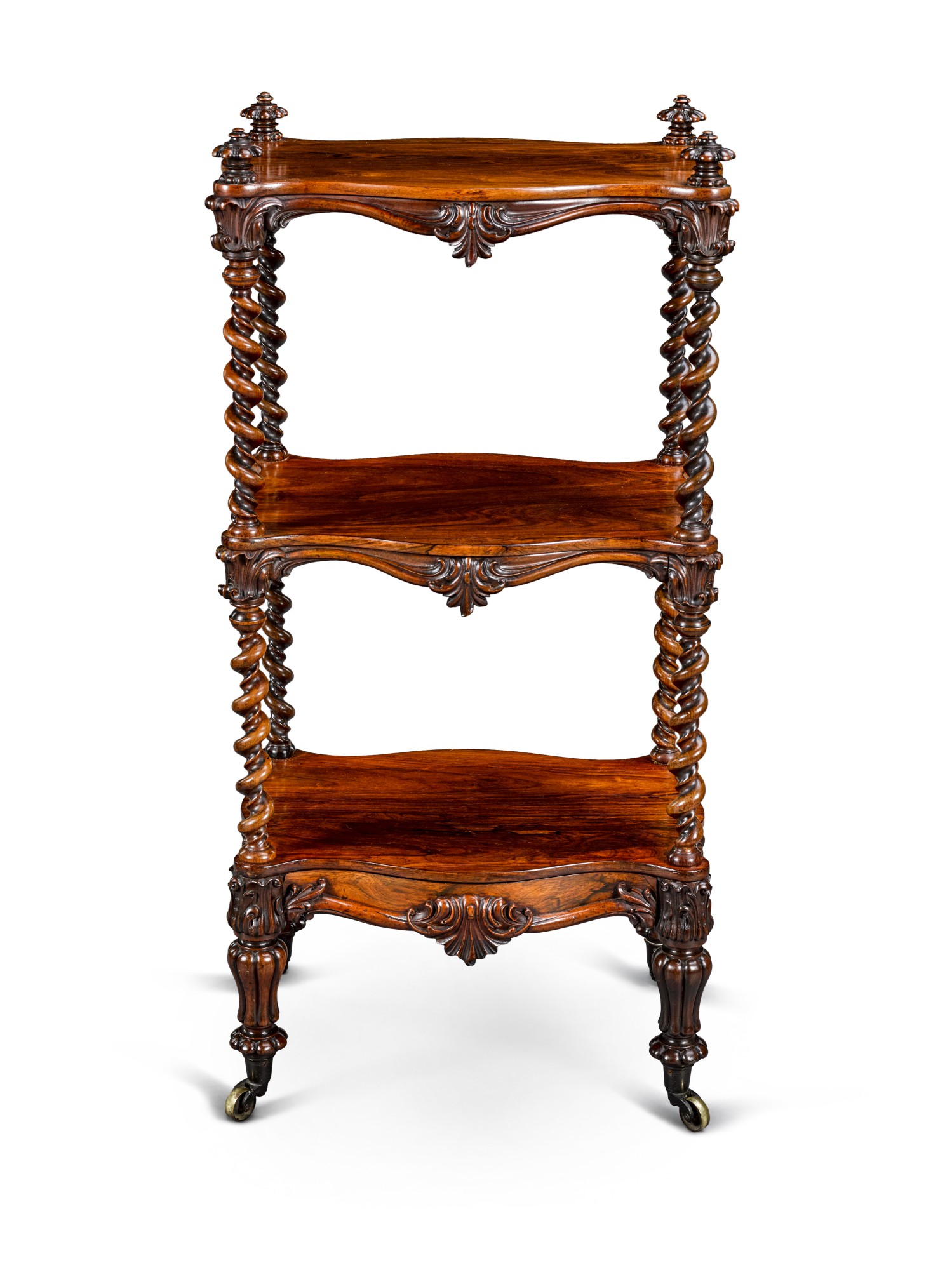 An early Victorian rosewood whatnot, circa 1840, in the manner of