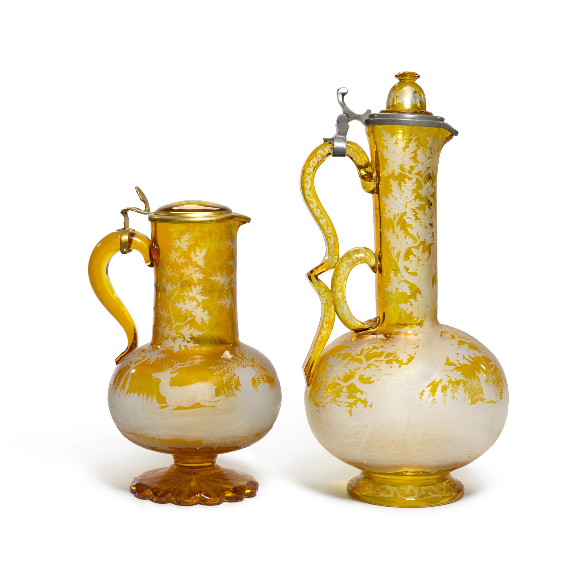 A Bohemian amberstained and engraved winejug and cover, and another