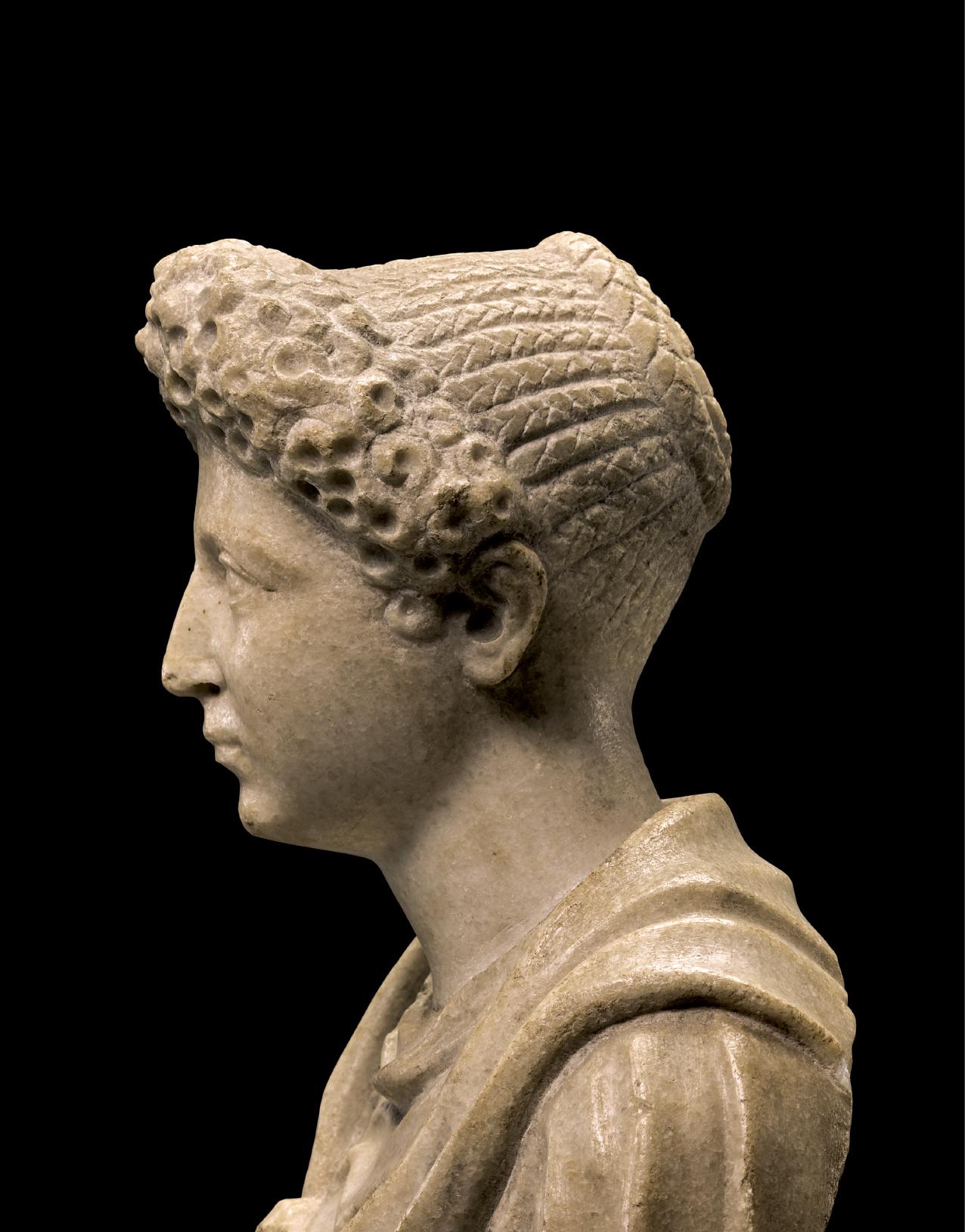 A ROMAN MARBLE HEAD OF A YOUNG WOMAN, FLAVIAN, LATE 1ST CENT. A.D., ON