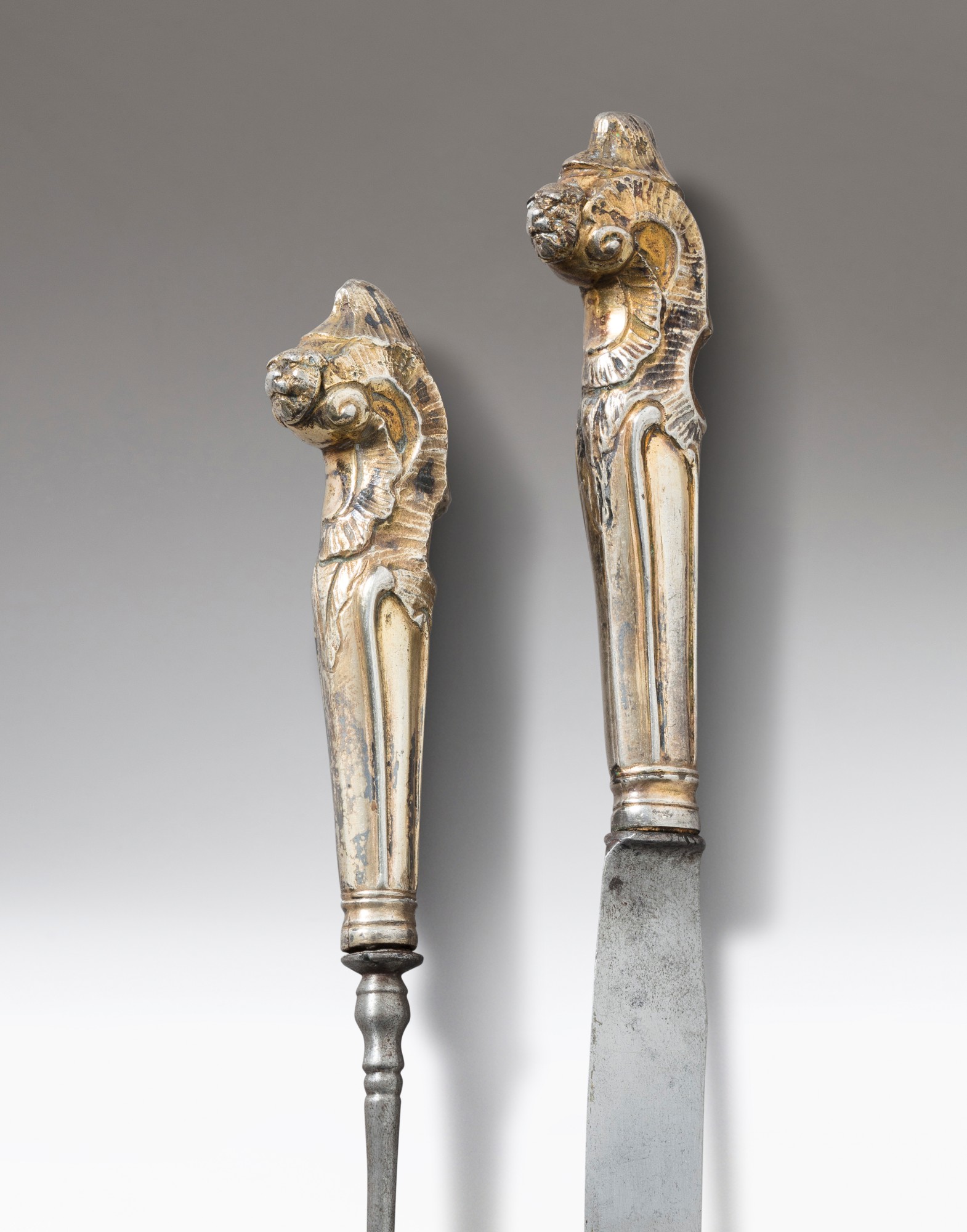 A fork and knife with silvergilt handles, unmarked, probably South