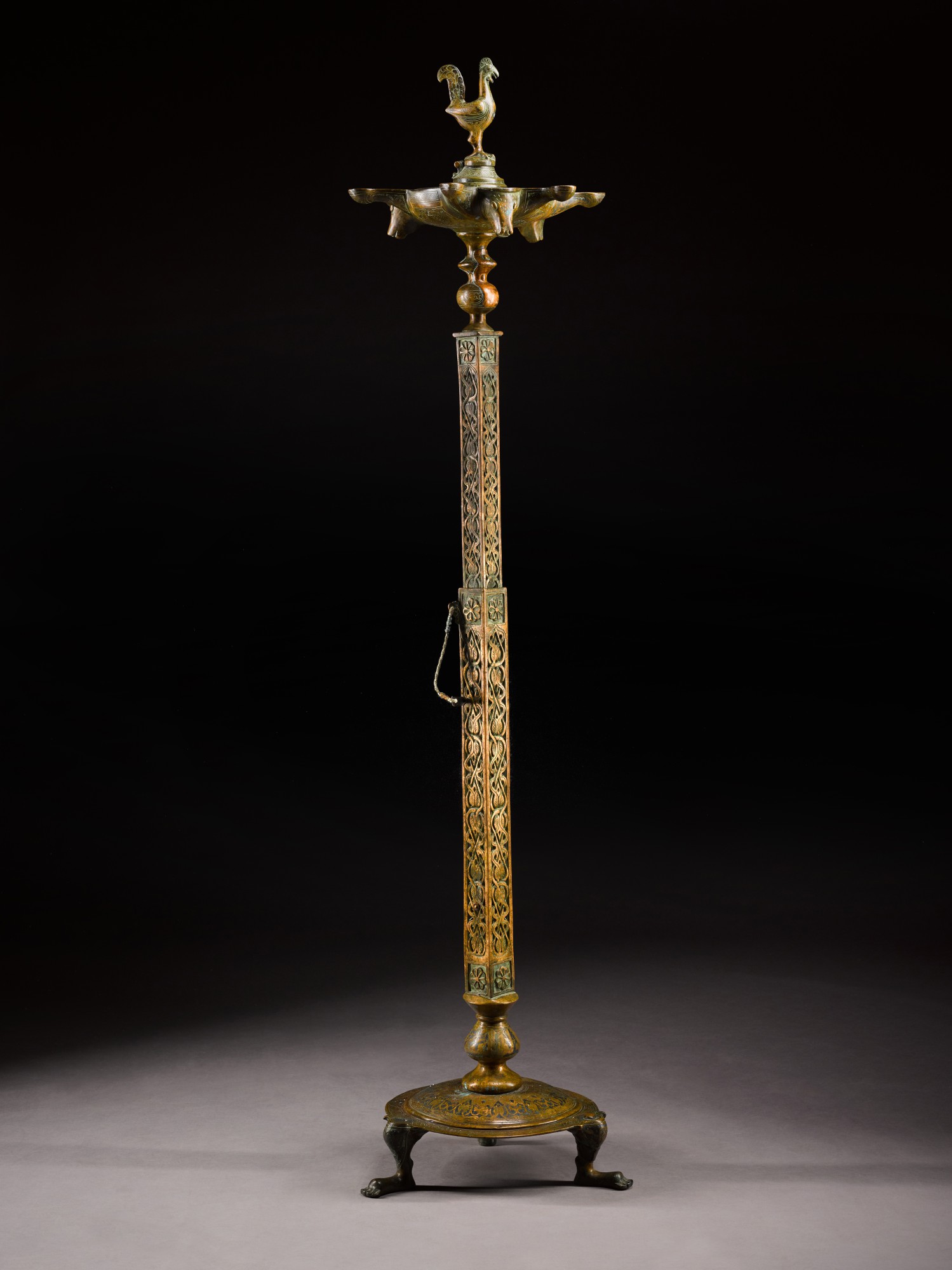 A monumental cast and engraved bronze multiplewick oil lamp, Andalusia