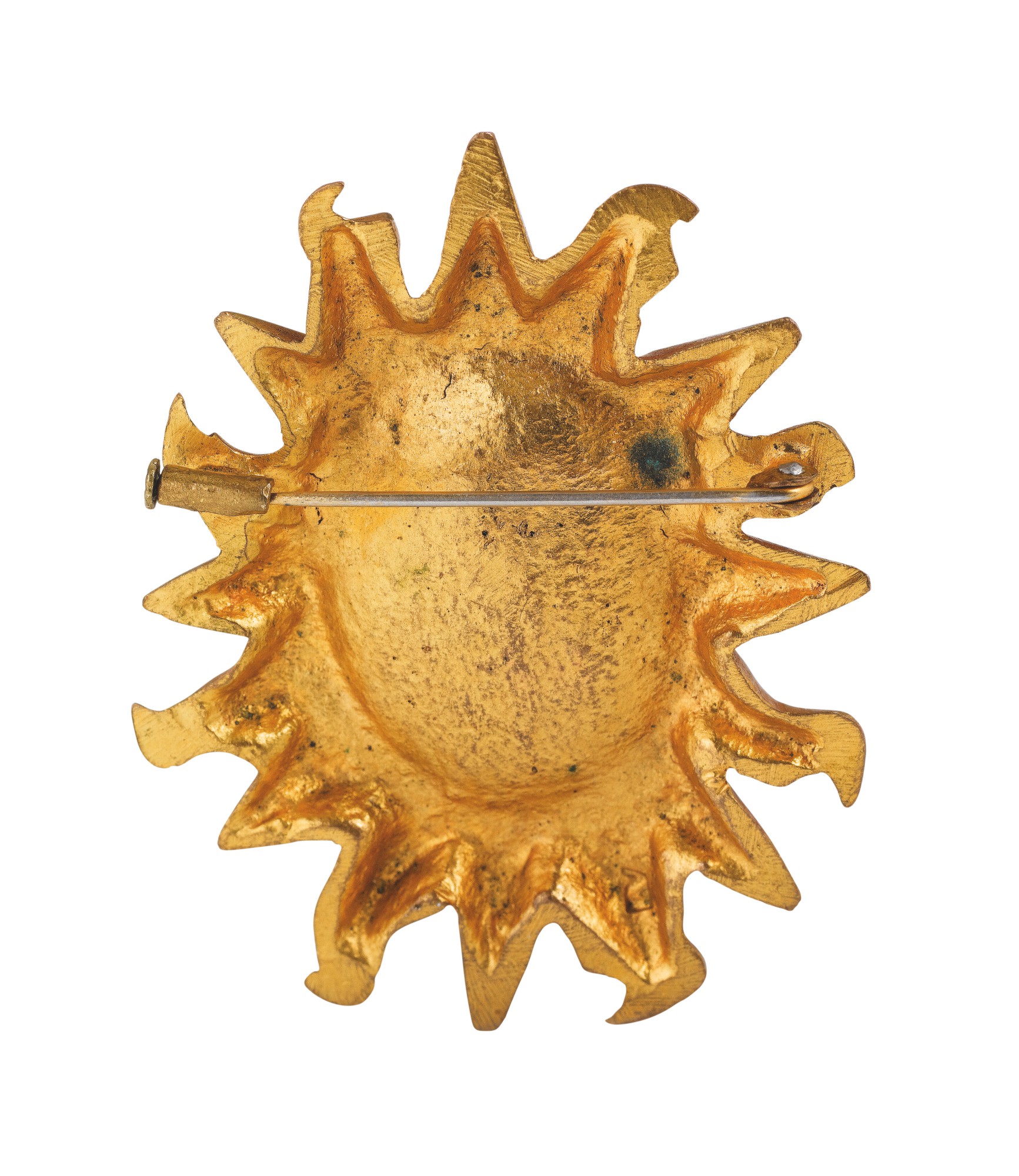 Yves SAINT LAURENT BROCHE soleil en metal doré. Signée