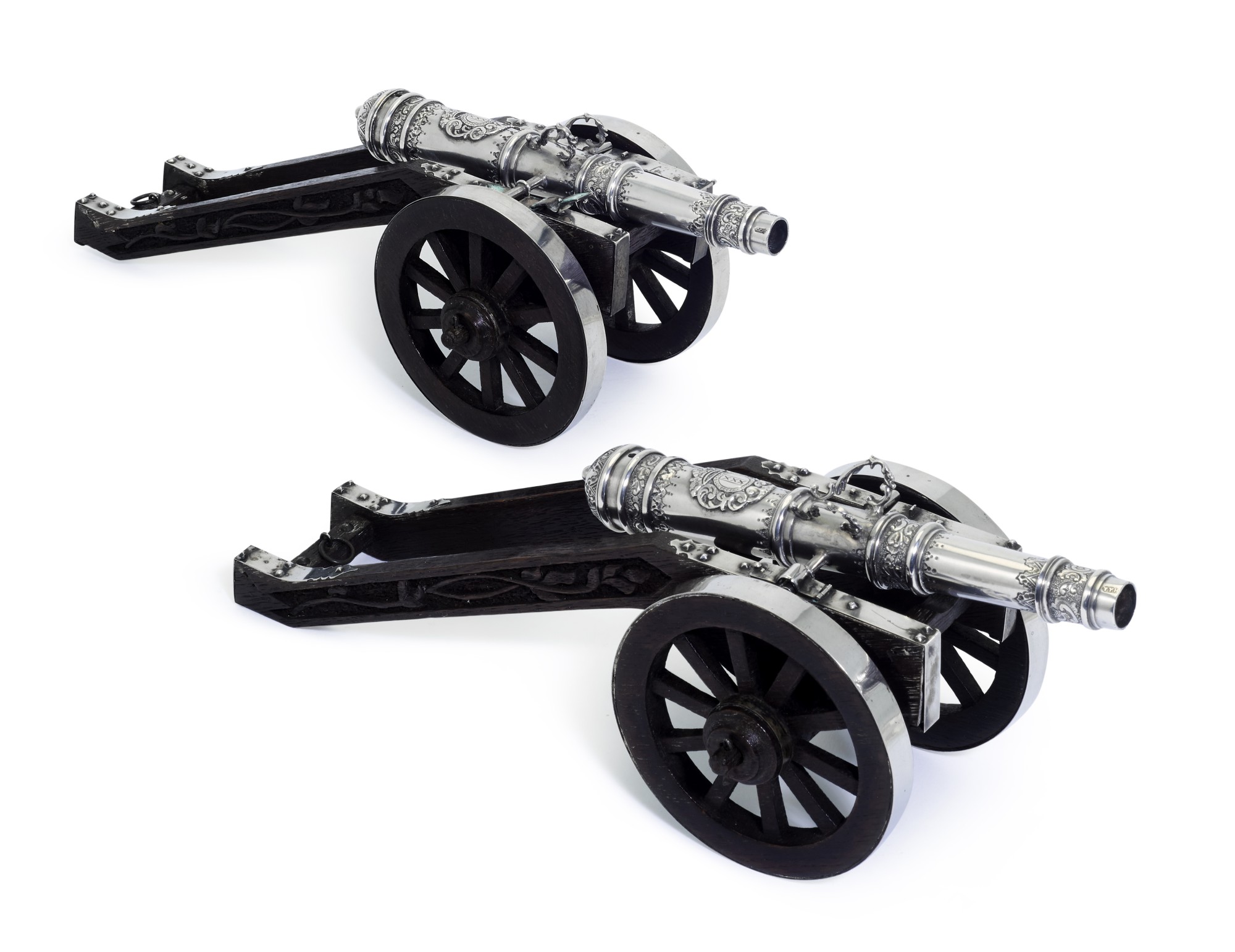 A pair of table ornaments in the form of miniature silver cannons and ...