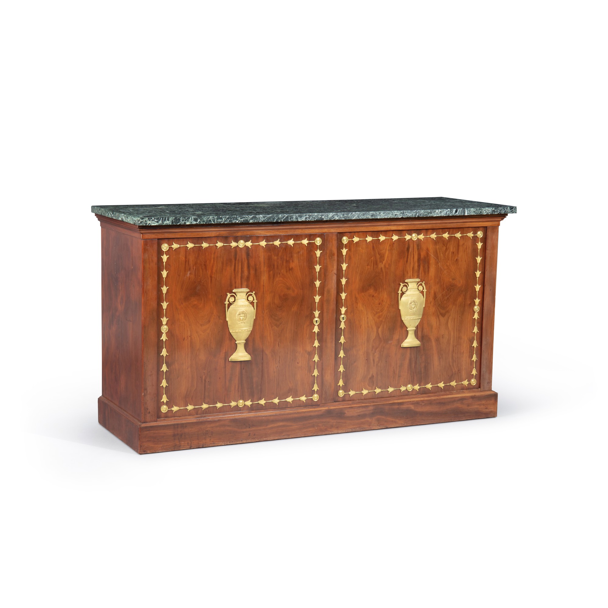 A giltbronze mounted mahogany commode, Empire, circa 1810 Commode à vantaux en acajou et