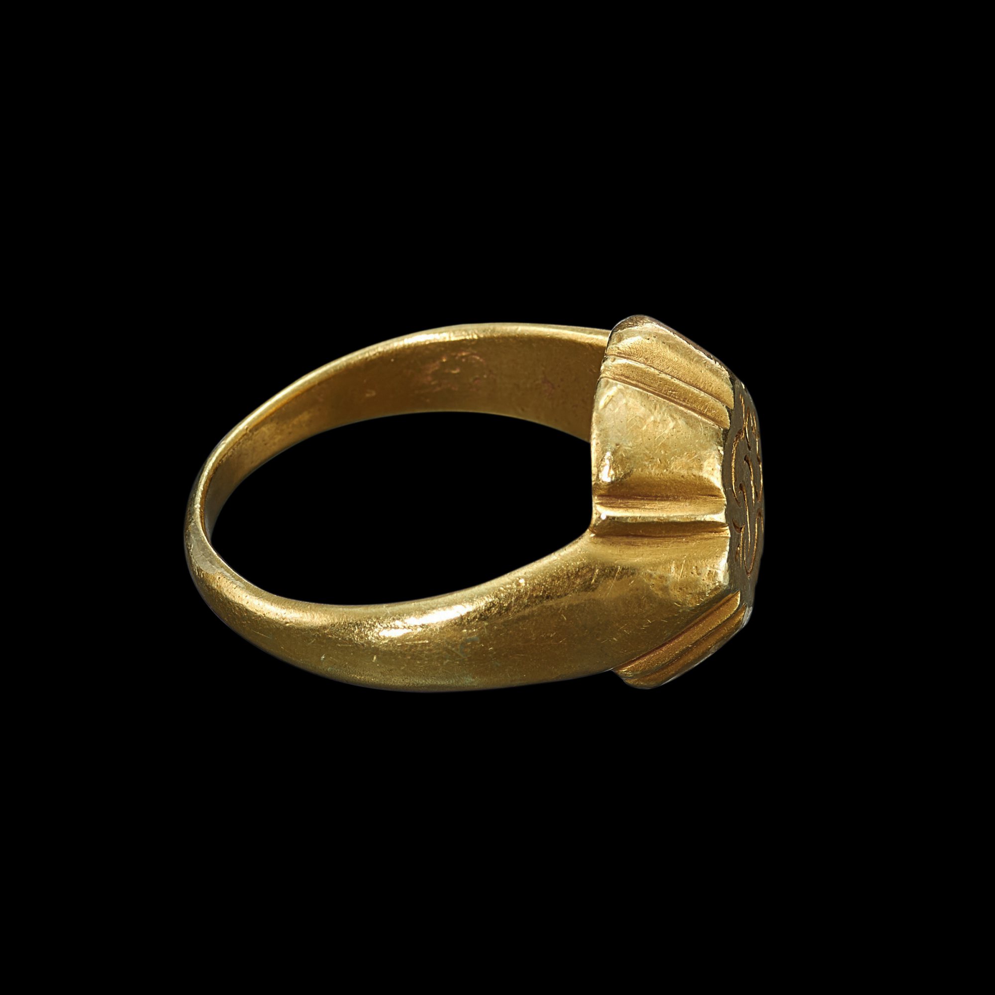 A solid gold ring with scallop shank and incised 'Sri' symbol Java ...