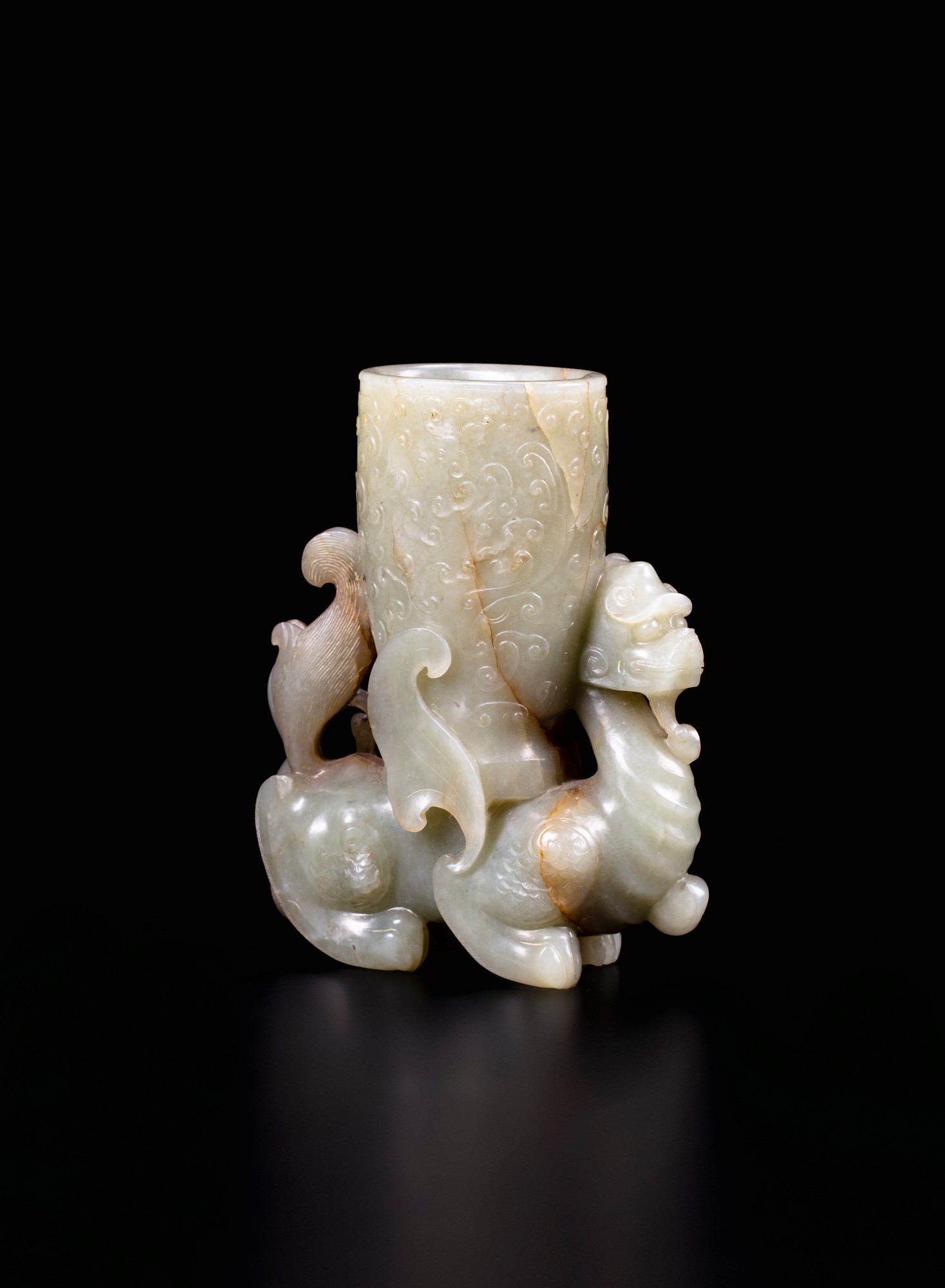 A finely carved celadon and brown jade archaistic 'mythical beast' vase