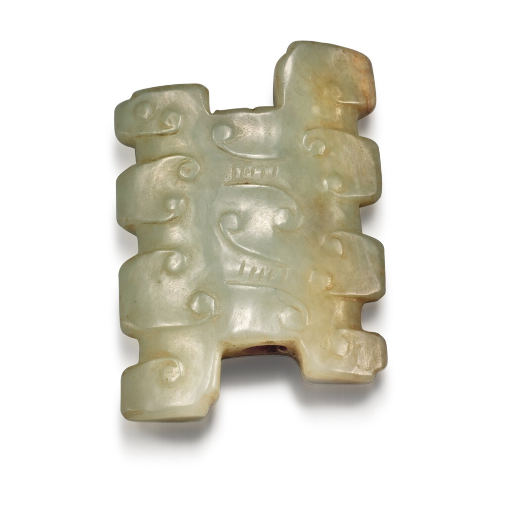 View full screen - View 1 of Lot 35. A pale green jade ornament, Eastern Zhou dynasty, Spring and Autumn period | 東周 春秋 玉勾雲紋飾.