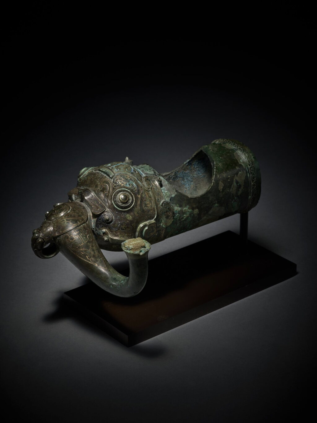 View full screen - View 1 of Lot 20. An exceptionally rare silver and gold-inlaid zoomorphic fitting Eastern, Zhou dynasty, Warring States period | 東周 戰國 銅錯金銀獸面紋部件.