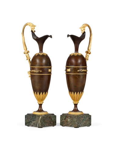View full screen - View 1 of Lot 126. A pair of patinated and gilt-bronze ewers, early 19th century | Paire d'aiguières en bronze patiné et doré du début du XIXème siècle.