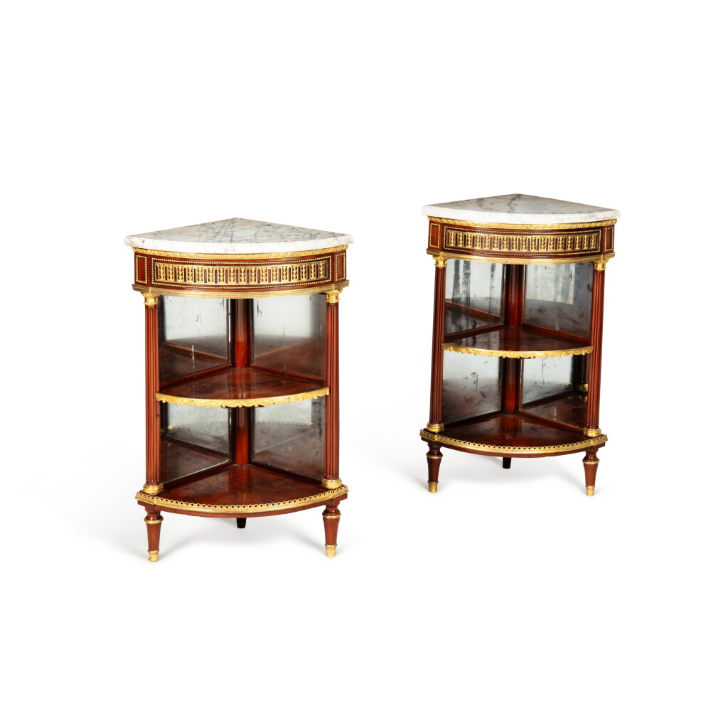 View full screen - View 1 of Lot 155. A pair of Louis XVI gilt-bronze mounted mahogany encoignures, circa 1780, attributed to Charles Erdmann Richet | Paire d'encoignures en acajou moiré et bronze doré, d'époque Louis XVI, vers 1780, attribuées à Charles Richet.