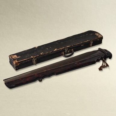 View full screen - View 1 of Lot 5729. A purple-lacquered and cinnabar lacquer-painted lianzhu-style guqin, Ming dynasty | 明 紫漆朱繪卷雲紋連珠式琴.