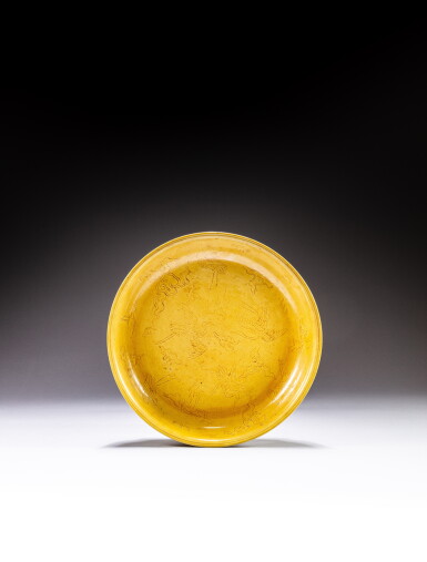 View full screen - View 1 of Lot 206. A large incised yellow-glazed 'phoenix' dish, Early Qing dynasty | 清初 黃釉暗刻鳳紋盤 《大明嘉靖年製》仿款.