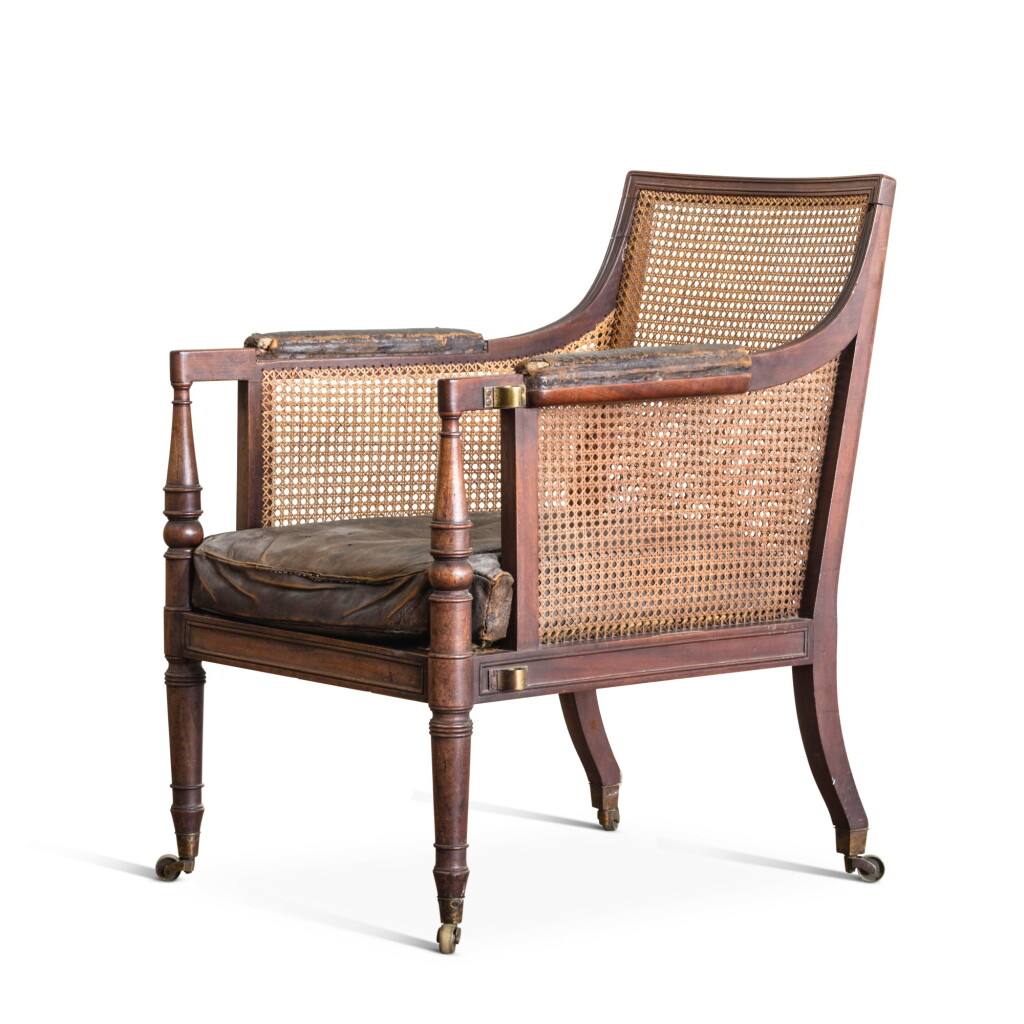 View full screen - View 1 of Lot 62. A GEORGE IV MAHOGANY AND CANE LIBRARY ARMCHAIR, CIRCA 1825, IN THE MANNER OF GILLOWS.