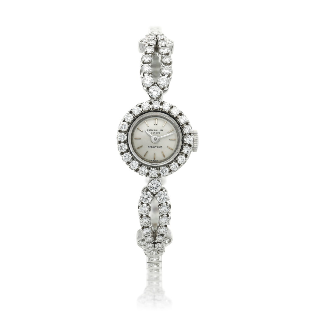 View full screen - View 1 of Lot 157. Retailed by Tiffany & Co.: A platinum and diamond-set bracelet watch, Circa 1950.