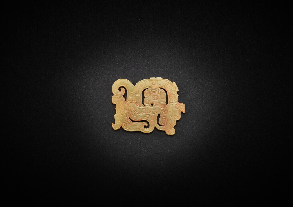 View full screen - View 1 of Lot 3805. A celadon jade openwork 'human-dragon' plaque, Mid - late Western Zhou dynasty | 西周中晚期 淺青灰玉透雕雙龍人首紋項飾.