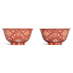 A fine pair of coral-red reverse-decorated 'lotus' bowls, Seal marks and period of Qianlong 清乾隆 珊瑚紅地留白纏枝蓮花紋盌一對 《大清乾隆年製》款