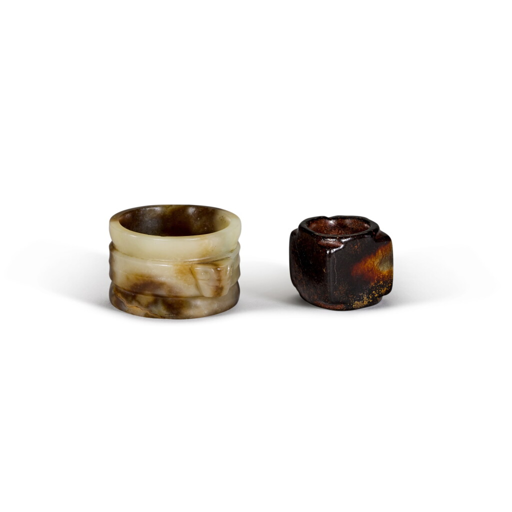 View full screen - View 1 of Lot 15. A small archaistic brownish-black jade cong and a jade ribbed tube with mask handles Ming dynasty | 明 仿古玉琮及圓箍形飾一組兩件.