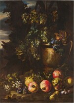 Still life with pomegranates, bunches of grapes, figs, and a carved stone urn in a forest landscape