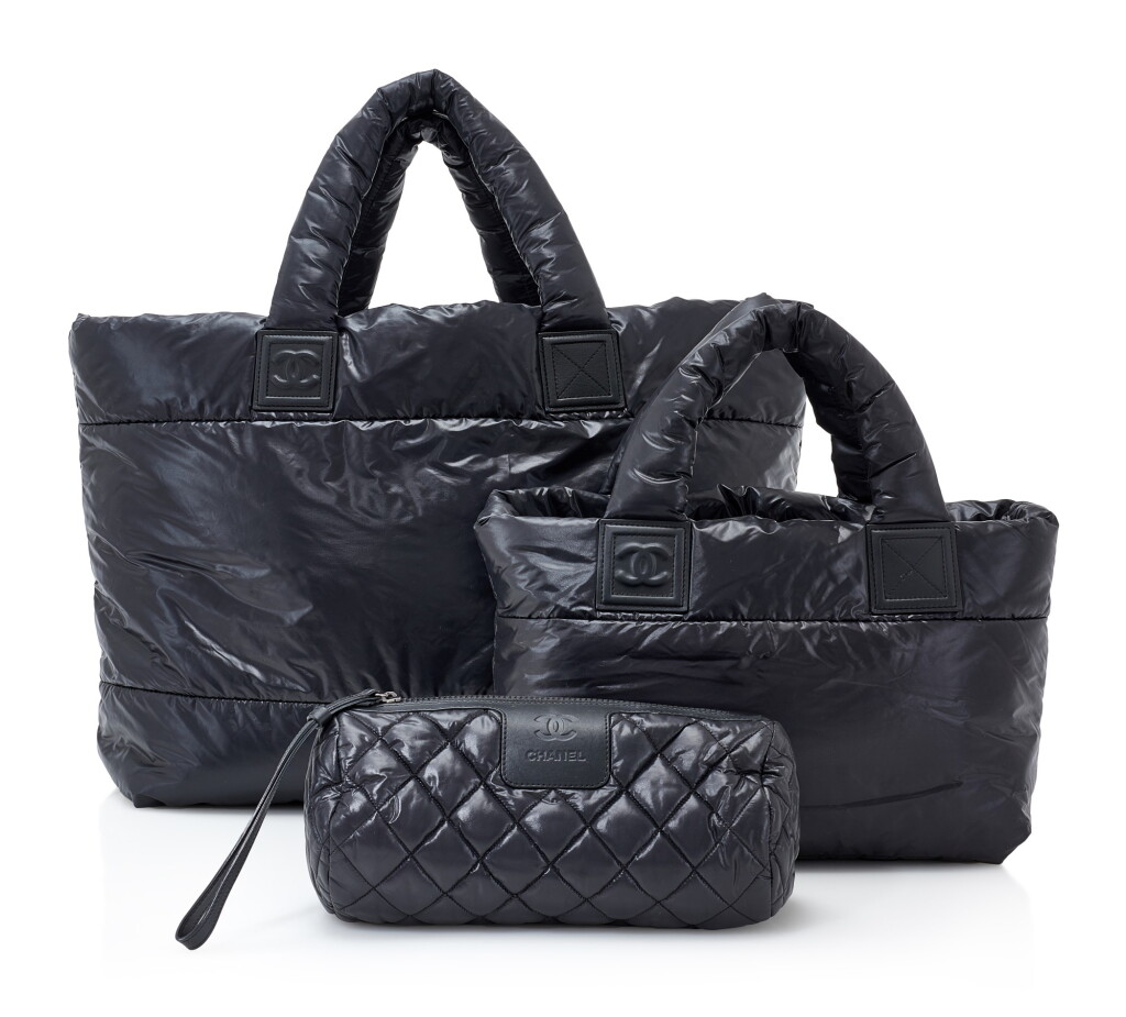 View full screen - View 1 of Lot 102. SET OF THREE BLACK/BURGUNDY PADDED NYLON COCO COCOON BAGS, CHANEL.