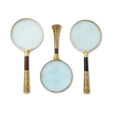 View full screen - View 1 of Lot 1185. A Group of Three Brass and Stained Mahogany Spanish Galllery Glasses, Each Formed with a Late-19th Century Damascened Handle.