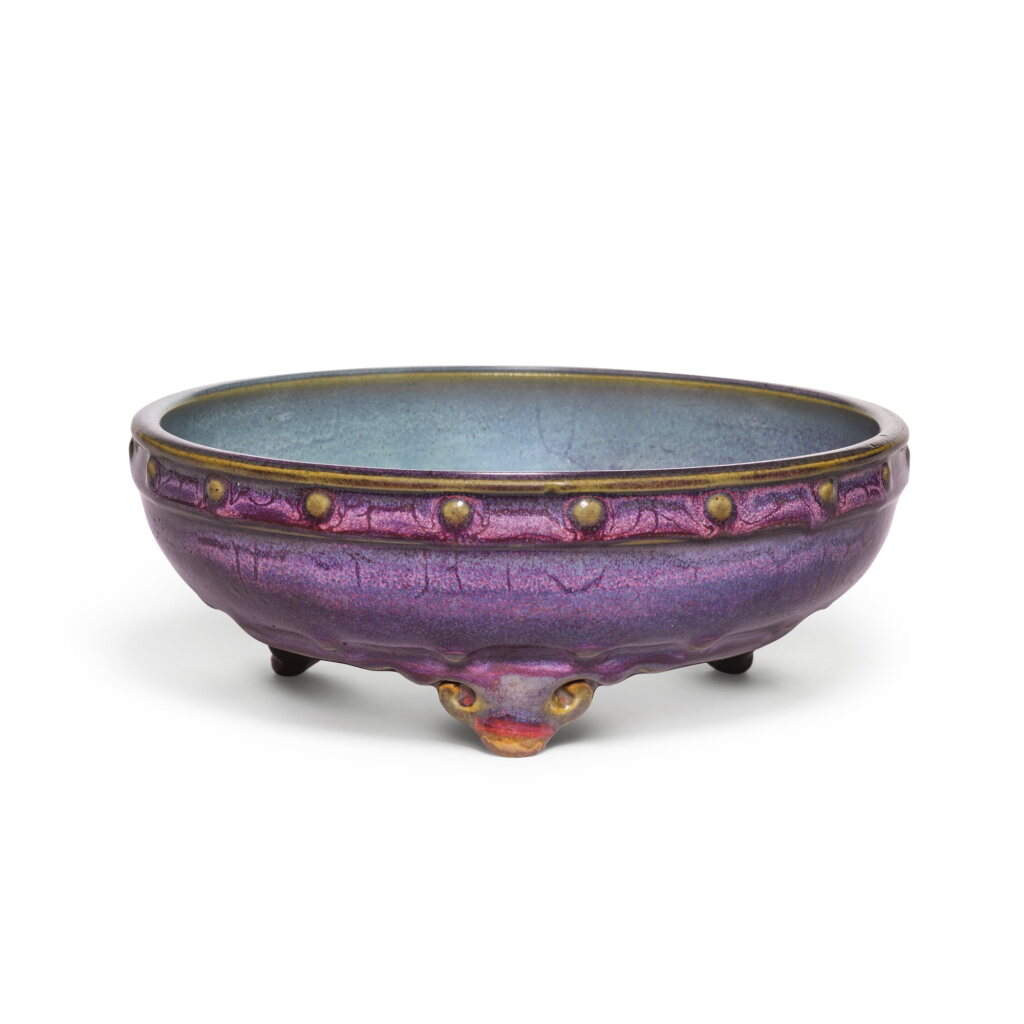 View full screen - View 1 of Lot 12. An exceptional Junyao purple and blue-glazed tripod narcissus bowl, Early Ming dynasty | 明初 鈞窰葡萄紫釉鼓釘三足水仙盆 底刻「五」字.