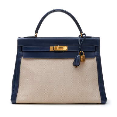 View full screen - View 1 of Lot 340. Navy Blue and Natural Kelly 32cm in Toile and Box Leather with Gold Hardware, 1979.