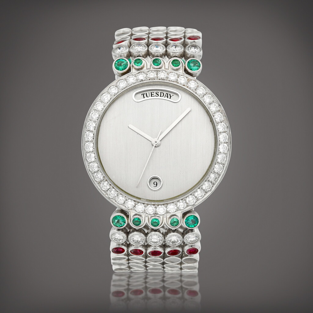 View full screen - View 1 of Lot 919. A platinum, diamond, emerald and ruby-set bracelet watch with day and date, Circa 2005 | 海瑞溫斯頓 | 鉑金鑲鑽石、綠寶石及紅寶石鏈帶腕錶,備日期及星期顯示,約2005年製.