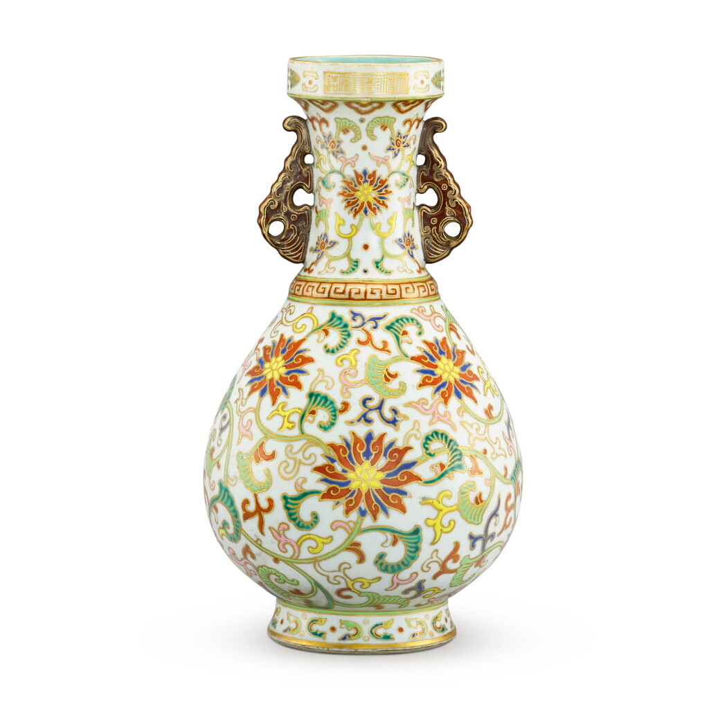 View full screen - View 1 of Lot 119. A RARE CLOISONNE-IMITATION WHITE-GROUND FAMILLE-ROSE VASE SEAL MARK AND PERIOD OF QIANLONG | 清乾隆 粉彩仿掐絲琺瑯番蓮花紋雙耳盤口瓶 《大清乾隆年製》款.