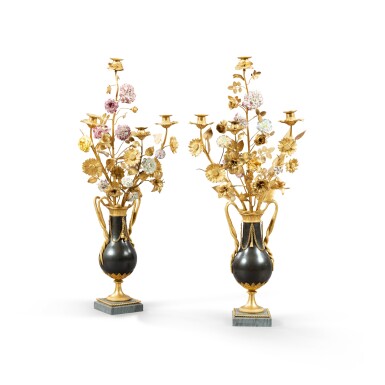 View full screen - View 1 of Lot 144. A pair of Louis XVI style gilt and patinated bronze and porcelain four-light candelabra, first half of 19th century | Paire de candélabres à quatre lumières en bronze doré et patiné et fleurs de porcelaine de style Louis XVI, première moitié du XIXe siècle.