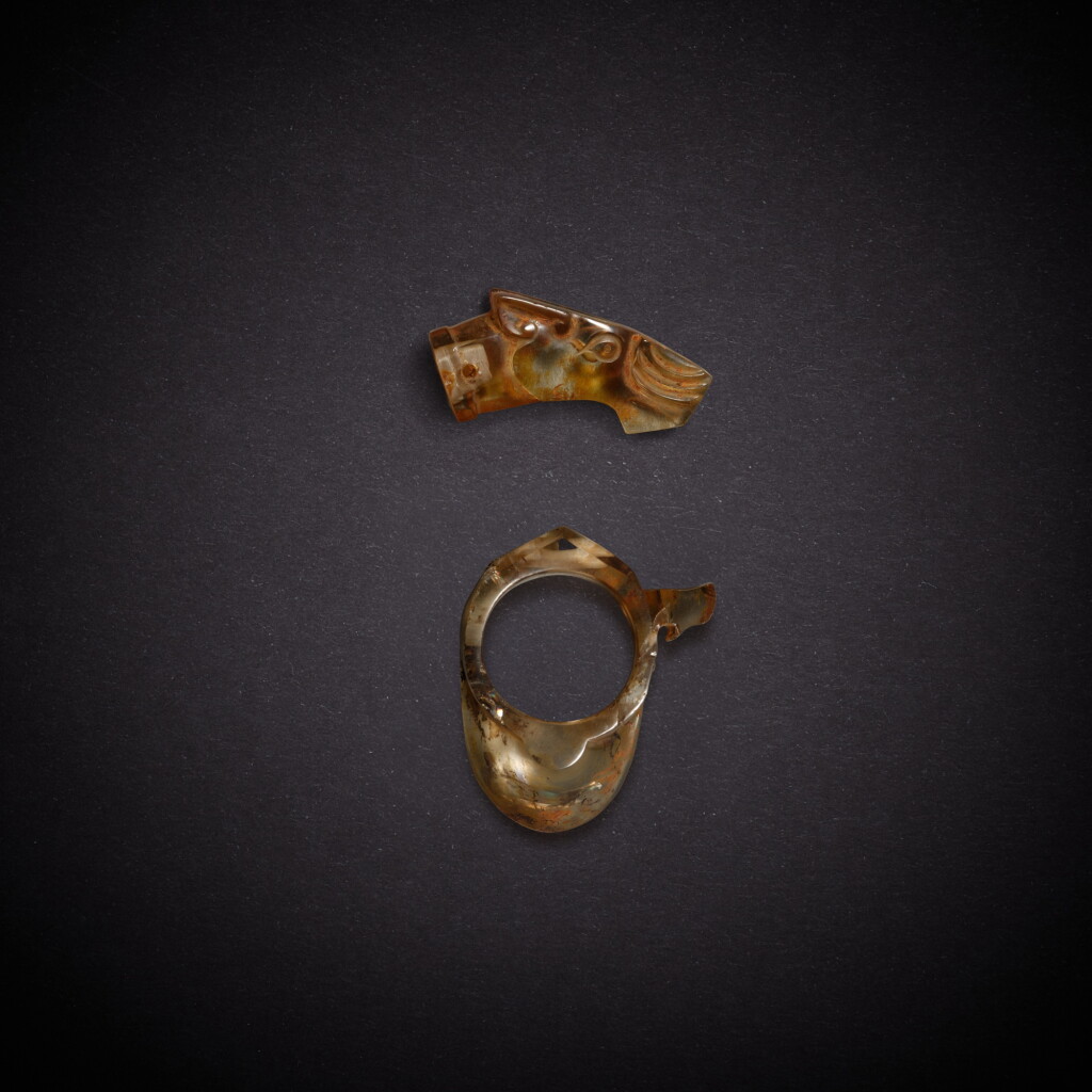 View full screen - View 1 of Lot 7912. Two rock crystal ornaments, Han dynasty | 漢 水晶韘一件 及 馬首端飾一件.