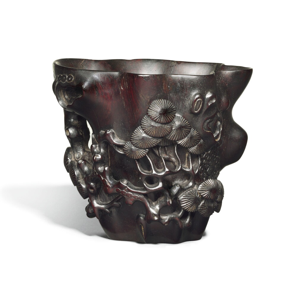 View full screen - View 1 of Lot 313. A ZITAN LIBATION CUP, QING DYNASTY, 19TH CENTURY | 清十九世紀 紫檀雕松樹樁盃.