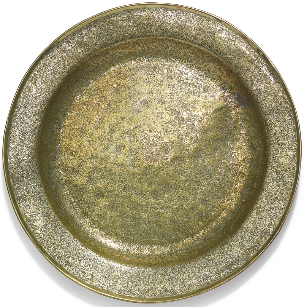 View full screen - View 1 of Lot 102. A MONUMENTAL MAMLUK 'VENETO-SARACENIC' BRASS DISH, EGYPT OR SYRIA, 15TH CENTURY.