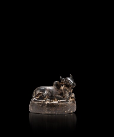 View full screen - View 1 of Lot 32. A bronze figure of Nandi, India, circa 15th century or later | 印度 約十五世紀或以後 銅神牛南迪臥像.