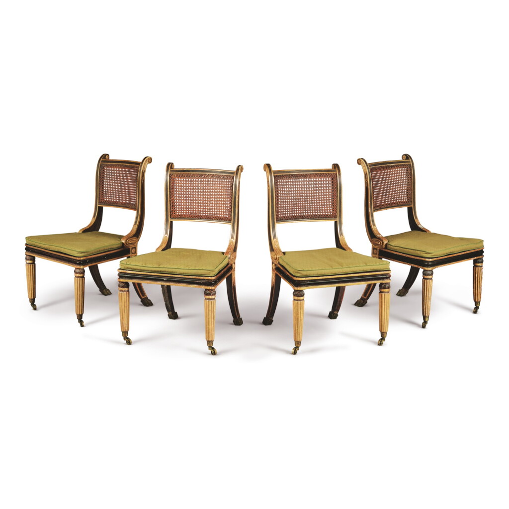 View full screen - View 1 of Lot 15. A SET OF FOUR REGENCY GILT AND EBONISED WOOD CANED SIDE CHAIRS IN THE MANNER OF HENRY HOLLAND, EARLY 19TH CENTURY.