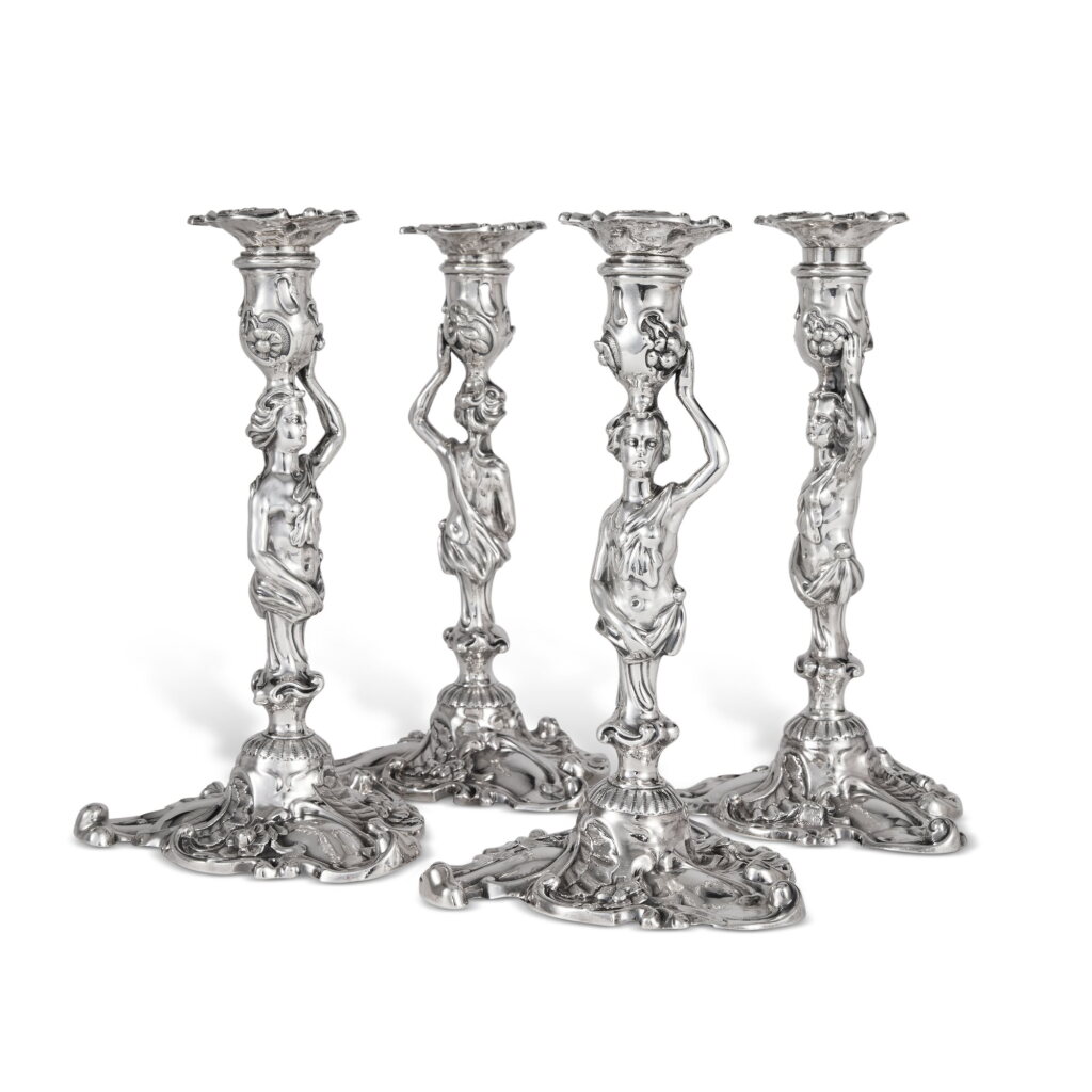 View full screen - View 1 of Lot 116. A Set of Four George II Silver Figural Candlesticks, Henry Hayens, London, 1750.