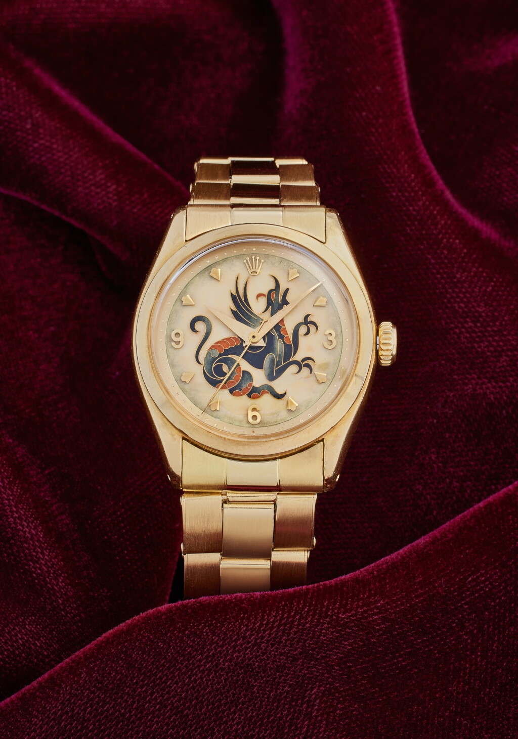 View full screen - View 1 of Lot 66. Reference 6100 'Dragon' | An exquisite and rare yellow gold automatic wristwatch with cloisonné enamel dial depicting a coiled dragon attributed to Master Enameller Nelly Richard and bracelet, Circa 1954.