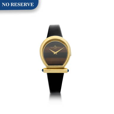 View full screen - View 1 of Lot 557. REFERENCE 38306 A YELLOW GOLD HORSESHOE SHAPED WRISTWATCH, CIRCA 1990.
