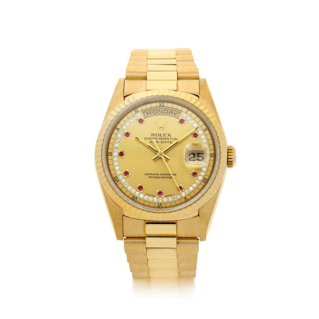 View full screen - View 1 of Lot 302. ROLEX | REFERENCE 18238 DAY-DATE A YELLOW GOLD, DIAMOND AND RUBY-SET AUTOMATIC WRISTWATCH WITH DATE, DAY AND BRACELET, CIRCA 1990.