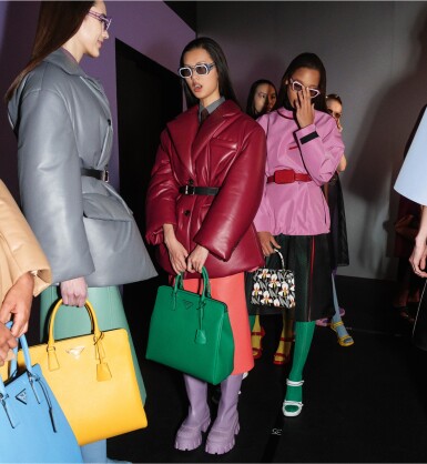 View full screen - View 1 of Lot 33. PRADA | NAPPA LEATHER PUFFER JACKET, CONTRASTING COLOR LEATHER SKIRT, ORGANZA SHIRT , POPLIN TIE, REVERSIBLE BELT, SAFFIANO LEATHER GALLERIA TOTE BAG AND LEATHER BOOTS, WORN BY SHUPING LI. UNIQUE LOOK NOT IN THE STORES.