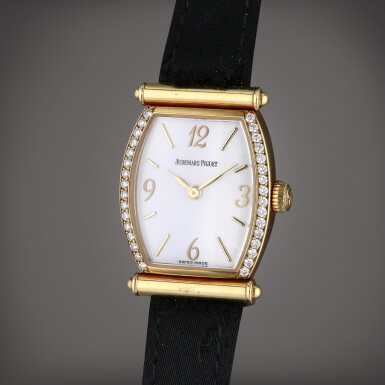 View full screen - View 1 of Lot 269. Carnegie | A yellow gold and diamond-set tonneau shaped wristwatch, Circa 1990.