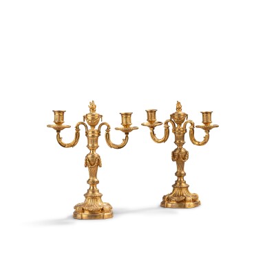 View full screen - View 1 of Lot 328. A pair of Louis XVI gilt-bronze two-light candelabra, circa 1775, in the style of Jean-Charles Delafosse.