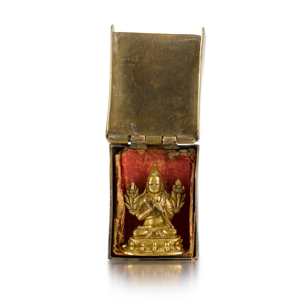 View full screen - View 1 of Lot 46. A miniature Sino-Tibetan gilt-bronze figure of a lama, box 18th century | 十八世紀 袖珍鎏金銅西藏喇嘛像及套盒.