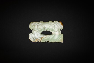 View full screen - View 1 of Lot 3771. A rare yellowish-celadon jade 'animal mask' ornament, Neolithic period, Hongshan culture, 4th - 3rd millennium BC | 新石器時代 紅山文化 公元前四千至三千年 青黃玉獸面紋卷雲形飾.