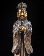A parcel-gilt bronze standing figure of a Daoist immortal, 17th century