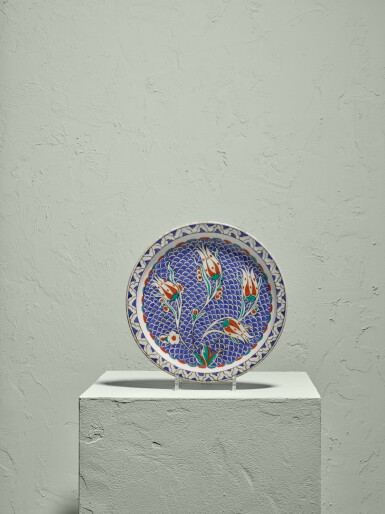 View full screen - View 1 of Lot 131. A rare Iznik polychrome pottery dish with tulips on scale ground, Turkey, circa 1580.