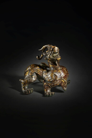 View full screen - View 1 of Lot 167. A superb and rare gold and silver-inlaid mythical beast (Bixie), Han dynasty.