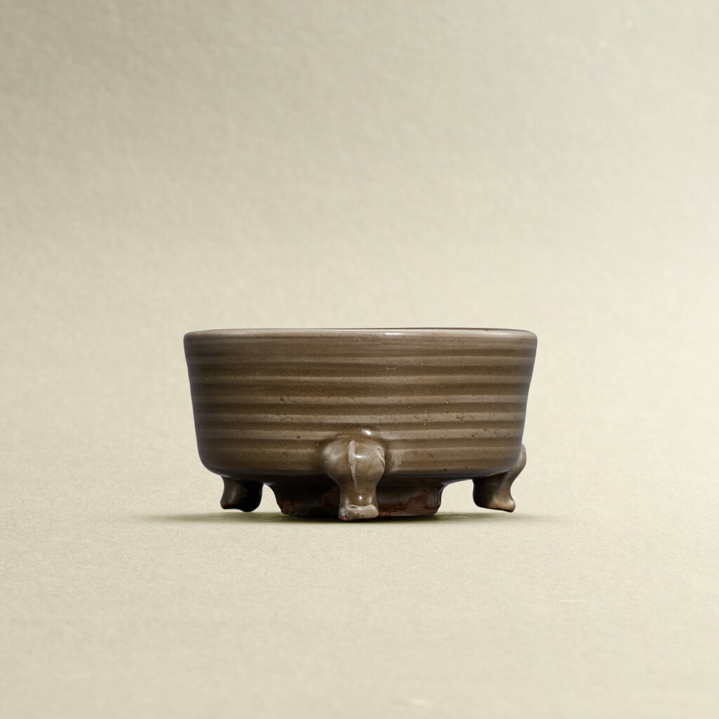View full screen - View 1 of Lot 5788. A Longquan celadon-glazed tripod incense burner, Yuan dynasty | 元 龍泉青釉弦紋三足爐.